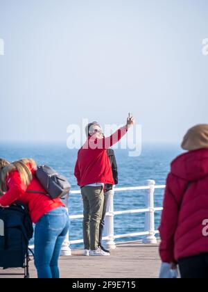 Constanta, Romania - 02.25.2021: Tourist couple taking a selfie on the seafront (faleza cazino) in Constanta, Romania Stock Photo