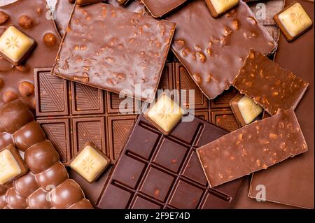 Hazelnut and almond milk and dark chocolate pieces. Delicious chocolate mix. Composition of bars and pieces of different milk and dark chocolate Stock Photo