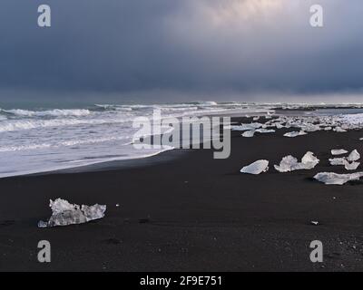 Beautiful view of famous diamond beach on the rough Atlantic coast with black sand and small icebergs in the south of Iceland near Jökulsárlón. Stock Photo