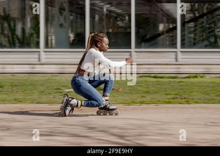 Side view of young masculine black male watching cellphone while using bike parking application in town Stock Photo