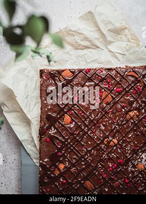 Closeup of a piece of chocolate bar with raspberry on a table Stock Photo