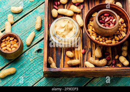 Peanut paste in glass jar.Peanut butter in bowl Stock Photo