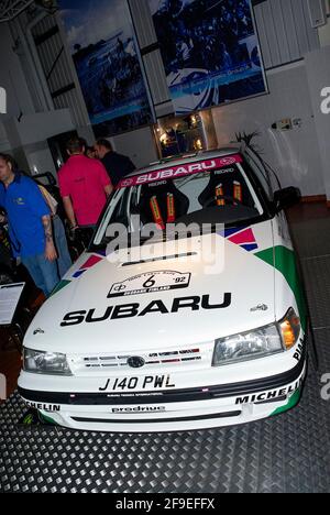 1993 Subaru Legacy Group A rally car driving up the hillclimb track at ...