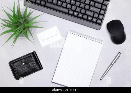 Shopping list, Internet shopping, online payments concept. Keyboard with computer mouse, credit card with wallet, blank notebook, pen on the desk Stock Photo