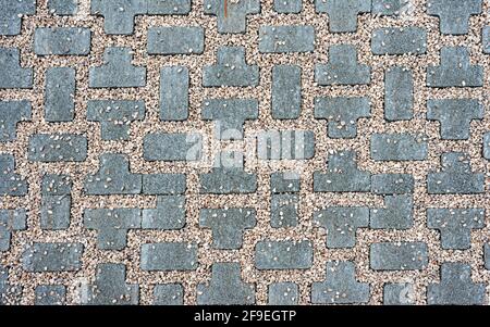 Interlocking paving with gray and white concrete blocks; Concrete products; Construction industry; Paved ground Stock Photo