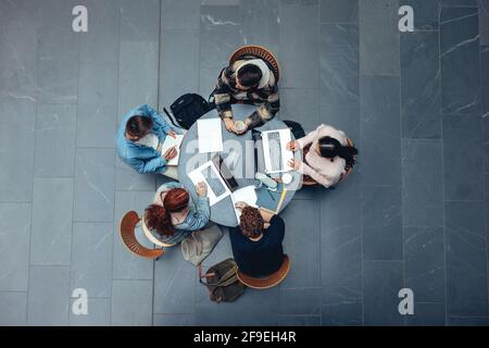 Top view of a young people preparing for exams in high school campus. Teenagers doing studies in college. Stock Photo