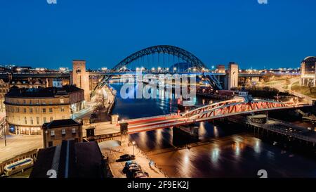 Newcastle upon Tyne UK: 30th March 2021: Newcastle Gateshead Quayside at night, with of Tyne Bridge and city skyline, long exposure during blue hour Stock Photo