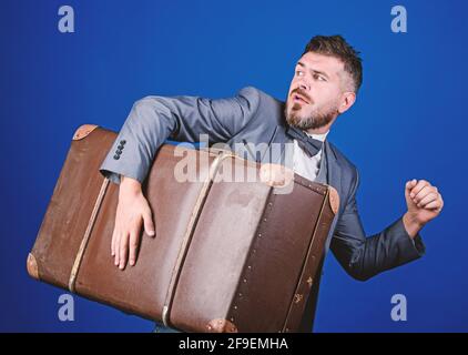 Thief run away with heavy suitcase. Theft of century. Delivery service. Travel and baggage concept. Hipster traveler with baggage. Baggage insurance Stock Photo