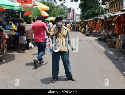 Kolkata, India. 18th Apr, 2021. A Kolkata Municipal worker announcing on the market to wear masks and maintain social distancing amid the spread of Covid-19 in Kolkata. (Photo by Sudipta Das/Pacific Press) Credit: Pacific Press Media Production Corp./Alamy Live News Stock Photo