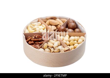 wooden round gift dish with triangular cells and mix of different types of nuts for a healthy diet of vegetarians isolated on white background, nobody Stock Photo