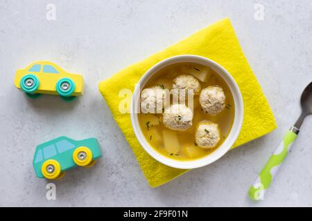 chicken soup for children in white bowl Stock Photo