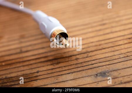 audio-video analog cable on an old wood table background. Stock Photo