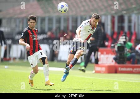 Milan, Italy, 18th April 2021. Kevin Strootman of Genoa CFC crosses the ball as Brahim Diaz of AC Milan closes in  during the Serie A match at Giuseppe Meazza, Milan. Picture credit should read: Jonathan Moscrop / Sportimage Stock Photo