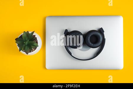Headphones lie on notebook. Stock Photo