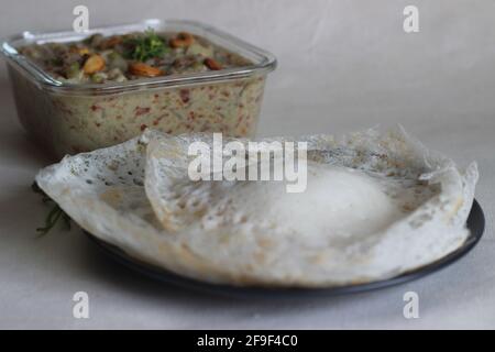 Fermented rice pancakes made with fermented rice batter and coconut milk served along with mixed vegetable ground coconut cashew gravy. Favourite of S Stock Photo