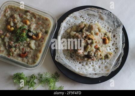 Fermented rice pancakes made with fermented rice batter and coconut milk served along with mixed vegetable ground coconut cashew gravy. Favourite of S Stock Photo