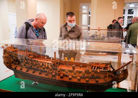 Moscow, Russia. 18th Apr, 2021. Visitors look at ship models during the Russian Championship and Moscow Open Cup in ship modelling in Moscow, Russia, on April 18, 2021. More than 160 models of ships and vessels, from the smallest ones 10-15 centimeters long to large models over 1.5 meters long, were presented during the competition. Credit: Alexander Zemlianichenko Jr/Xinhua/Alamy Live News Stock Photo