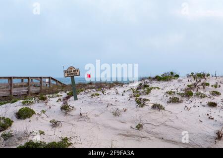 Sand dunes with 'Keep off Dunes' sign on the beach at Gulf Shores, Alabama, USA Stock Photo