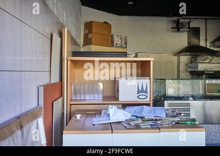 Looking in through the window to a closed by Covid takeaway restaurant Stock Photo