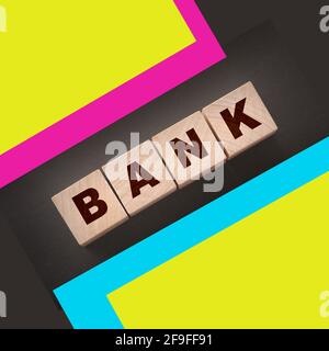 Bank word concept written on wooden cubes on black table. Banking saving financial investment concept. Stock Photo