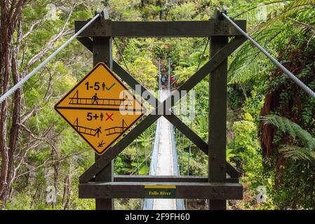 Nz Track Sign Warning signs about a suspension footbridge in Abel Tasman Cost Track ...