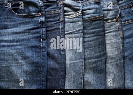 Close up of various blue jeans. Fashion clothing concept. Stock Photo