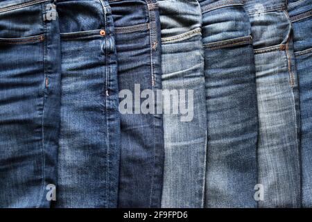 Close up of various blue jeans. Fashion clothing concept. Stock Photo