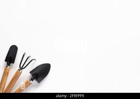 Gardening tools on white background. Small shovel, scapula and rake for planting Stock Photo