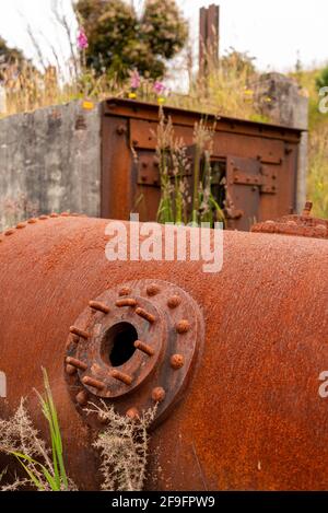 Remains in the landscape of an old mining factory in the ghost town of Waiuta, South Island of New Zealand Stock Photo
