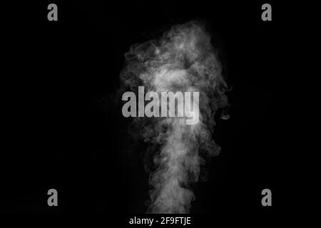 Figured smoke on a dark background. Abstract background, design element, for overlay on pictures. White smoke on black background. Stock Photo