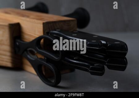 Set of kitchen knives and scissors in a wooden stand Stock Photo