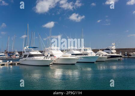 Puerto del Carmen, Lanzarote, Canary Islands, Spain. Motor yachts moored in the marina at Puerto Calero. Stock Photo