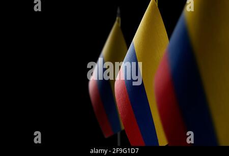 Small national flags of the Colombia on a black background Stock Photo