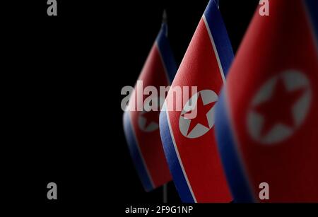 Small national flags of the North Korea on a black background Stock Photo