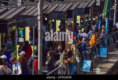 London, United Kingdom. 18th April 2021. Busy food stalls in Camden Market. People flocked outside over a busy weekend as lockdown rules are relaxed in England. Credit: Vuk Valcic/Alamy Live News Stock Photo