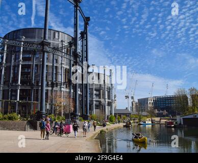 London, United Kingdom. 18th April 2021. People walk past the Gasholders Buildings in King's Cross. Crowds flocked outside over a busy weekend as lockdown rules are relaxed in England. Credit: Vuk Valcic/Alamy Live News