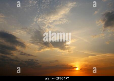 Sunset on colorful sky, clouds in the pink and orange sunlight. Picturesque landscape for background with soft colors Stock Photo
