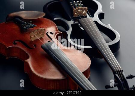 Wooden retro violin and modern electric viola Stock Photo