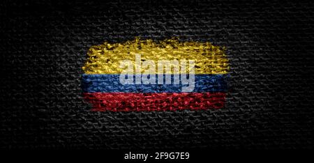 National flag of the Colombia on dark fabric Stock Photo