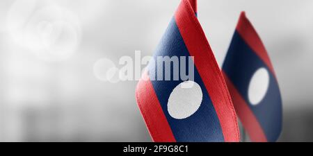 Small national flags of the Laos on a light blurry background Stock Photo