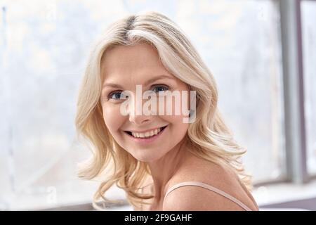 Mature smiling 50s woman portrait looking at camera. Stock Photo