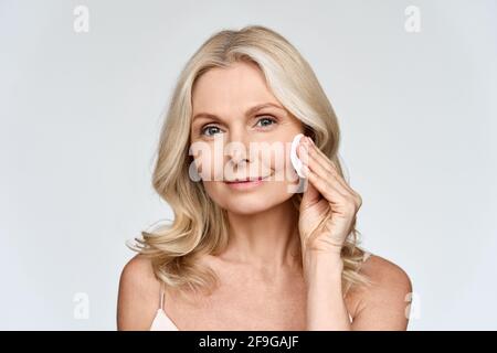 Portrait of woman holding cotton pad doing everyday routine makeup removing. Stock Photo