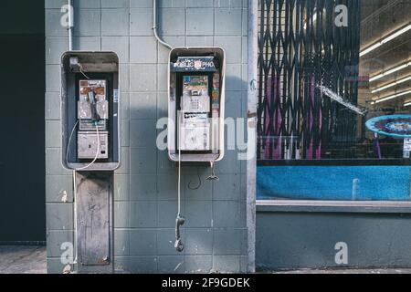 Broken public phone in the streets of Los Angeles, California, USA Stock Photo