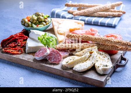 typical Italian antipasto with salami and cheese on a cutting board Stock Photo