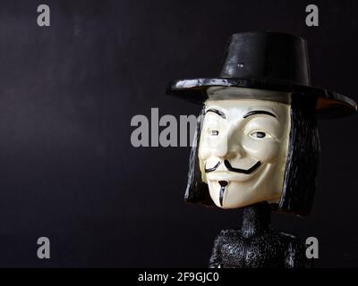 closeup of a dark puppet's head with a whiteboard on the bottom Stock Photo