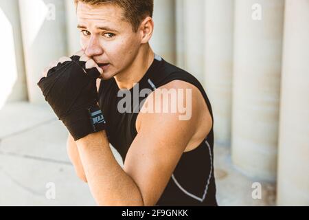 Man exercising and fighting in outside, boxer in gloves. male boxer portrait Stock Photo