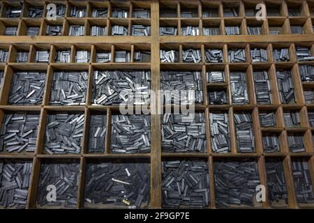 Letterpress letters placed in printing cabinet, old printing press. Stock Photo