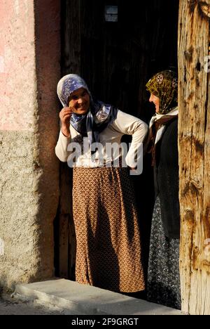 Women in front door, headscarf, Guezelyurt, Cappadocia, Turkey Stock Photo