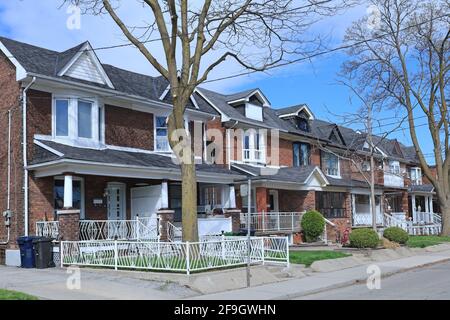 Street with block of older row houses with gables Stock Photo