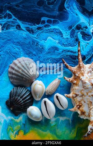 Seashells on a bright background. Acrylic Pouring Stock Photo